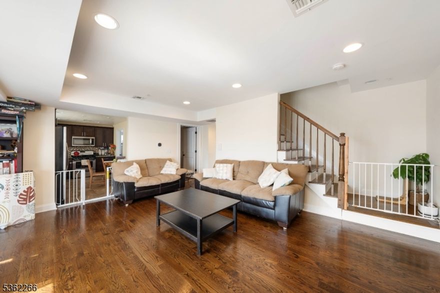 Welcome to this bright and spacious multi-level condo, ideally located just three blocks from the train station and vibrant downtown Linden! This newer unit offers an unbeatable blend of comfort and convenience, perfect for commuters and anyone who loves being close to it all. Step inside to find a sun-drenched living room with large windows that fill the space with natural light. The main level features a roomy layout, including a powder room, an eat-in kitchen perfect for casual dining, and a dedicated laundry room for added convenience. Upstairs, you'll find two generously sized bedrooms and a full bath. The primary bedroom boasts a walk-in closet and lots of space, making it a comfortable retreat. Additional features include central air conditioning and heating, one assigned parking space, and a dedicated storage area on the ground level ideal for bikes, seasonal items, or extra belongings. Don't miss this move-in ready gem in a highly desirable location   schedule your showing today!