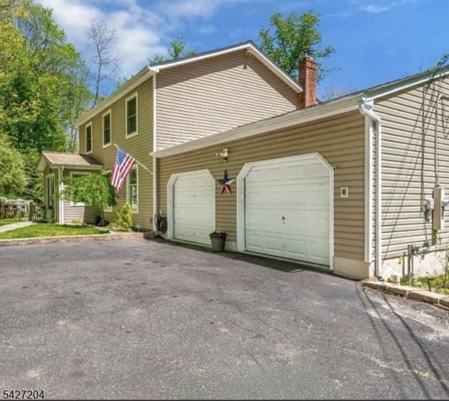 Set on a private, wooded lot with the added bonus of an included .25-acre neighboring lot, this well-maintained colonial offers space, privacy, and an ideal setup for both everyday living and entertaining. The main level features hardwood floors throughout the living and dining rooms, along with a warm and inviting living area anchored by a built-in electric fireplace. The spacious eat-in kitchen opens directly to the outdoors, where sliding doors lead to a deck with pergola overlooking a thoughtfully designed backyard retreat. Enjoy summer to the fullest with an above-ground pool, surrounding deck, patio, and dedicated pool bar creating a true indoor-outdoor lifestyle. Upstairs, the primary suite includes a full en-suite bath, complemented by two generously sized additional bedrooms and another full bathroom. The finished walk-out basement expands your living space with a rustic wood-burning stove framed by custom stonework and a built-in dry bar perfect for entertaining, recreation, or relaxing. A separate laundry room and additional storage complete this level. Conveniently located near Routes 80, 46, and 206, as well as the Mt. Arlington train station and Lake Hopatcong, this home offers a unique blend of privacy, functionality, and commuter-friendly access. Extra Lot, 7 Celia Ave (Lot size: 10,454 sq ft/ Acreage 0.24 acres), is negotiable/option to purchase together with 13 Celia (Lot size: 33,100/Acreage: 0.76 acres).