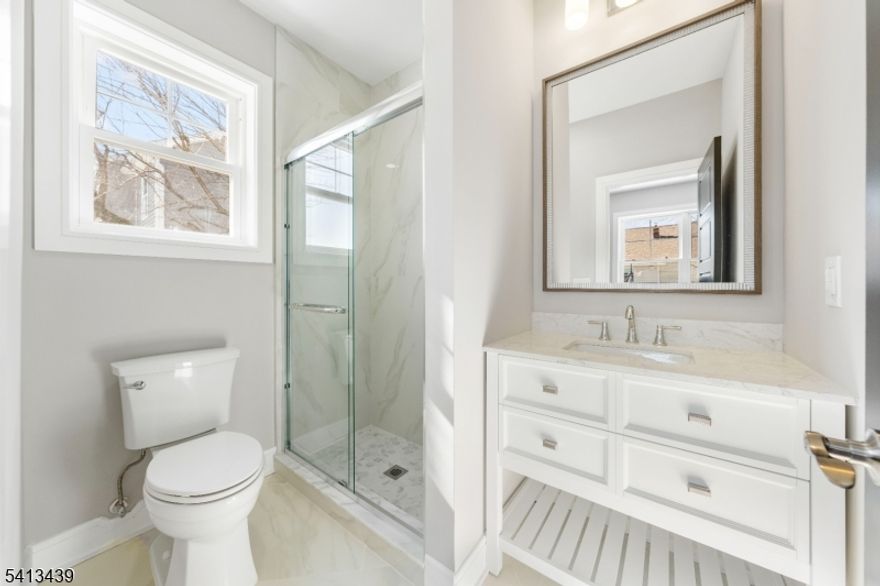 Welcome to this reimagined turnkey colonial completely updated for 2026! Inside you'll discover a sun-drenched, open-concept design highlighted by light oak hardwood floors and striking custom millwork. The heart of the home is a chef's kitchen featuring two-tone shaker cabinetry, a center island with bar seating, and sliding glass doors that lead directly to your private, fully fenced backyard. The main level is an entertainer's dream, flowing seamlessly into a formal dining room, living room, and a cozy family room anchored by an elegant electric fireplace. A highly coveted first-floor bedroom with an adjacent full bath, a practical mudroom, and a stylish half bath complete the main floor. Upstairs is your private hideaway. The sprawling primary suite boasts dramatic vaulted ceilings, a flexible attached space ideal for a home office, and a spa-like en suite with a freestanding soaking tub and glass shower. The second floor also features a generous princess suite, two additional beautifully appointed bedrooms, a full common bath, and a dedicated laundry room to make chores a breeze. The living space extends into the fully finished basement, offering a versatile recreation room and another full bath. Commuting is easier from a home perfectly situated between Vauxhall Road and Morris Avenue for quick access to local buses.