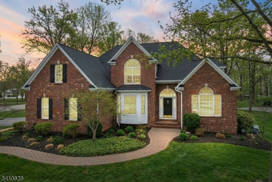 This beautifully cared for Colonial presents a spacious interior with plenty of natural light. The foyer introduces the home and opens to a dramatic living room with high ceilings, along with a welcoming two story family room featuring a brick gas fireplace. The kitchen provides abundant cabinetry, granite counters with breakfast bar, new appliances in 2025, and a bright eat-in area with access to a deck overlooking the private one acre corner lot, ideal for relaxing or entertaining. A desirable first floor primary suite offers comfort & privacy, complete with California closets and a beautifully renovated bathroom featuring dual vanities, a soaking tub, and a separate shower. The main level also includes a renovated powder room & a convenient laundry room. Upstairs, generously sized bedrooms offer ample closet space, including new carpeting in two bedrooms. Hardwood flooring runs through several of the main living spaces, while Andersen windows enhance the home's bright and open feel. A full walk in attic on the second level provides excellent potential for an exercise room, additional bedroom, or expansive custom closet. Additional highlights include a two car garage with new garage doors and openers, a double wide blacktop driveway, exterior generator hookup, New roof, gutters, and hot water heater were just installed in 2025. Move in ready and located in a Blue Ribbon School District, this home is close to shopping and dining and just a short drive to downtown Princeton.