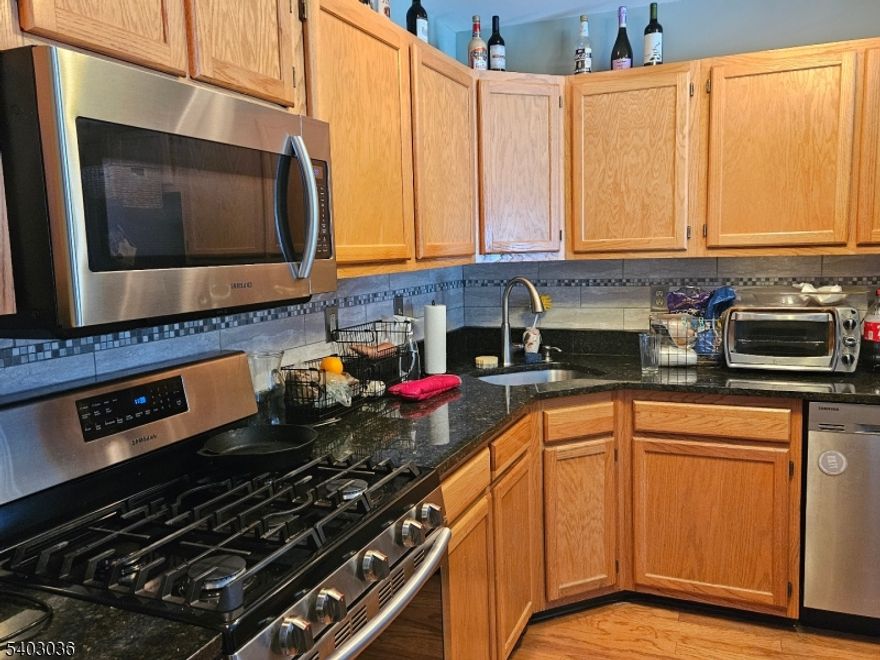 PROFESSIONAL PHOTOS COMING SOON - Step into this beautifully upgraded Alpine model, where every detail is designed for modern living..The open floor plan creates a welcoming atmosphere. Enjoy cozy evenings by the fireplace, featuring a stylish slate surround and classic white mantle, or step through the sliders onto your private patio an ideal spot to unwind while taking in the serene backyard and the sights and sounds of nearby birds and wildlife. The spacious master suite is a true retreat, boasting a vaulted ceiling, walk-in closet, and a luxurious master bath with a large shower, skylight, double-sink vanity, and linen closet.  The second level also features a generously sized bedroom, a full bath, and a flexible den perfect for work or hosting guests. The kitchen is a chef's dream, equipped with newer Samsung appliances, a five-burner range, granite countertops, and a breakfast bar for casual meals and gatherings. Additional conveniences include a first-floor powder room and a separate laundry room, adding to the home's functionality and ease. Enjoy peace of mind with a new roof and take advantage of the Seasons Glen community amenities: a sparkling pool, well-equipped gym, tennis and basketball courts, playground, and a welcoming clubhouse. All this, just minutes from shopping, dining, and major commuting routes, makes this home the perfect blend of relaxation, recreation, and convenience.