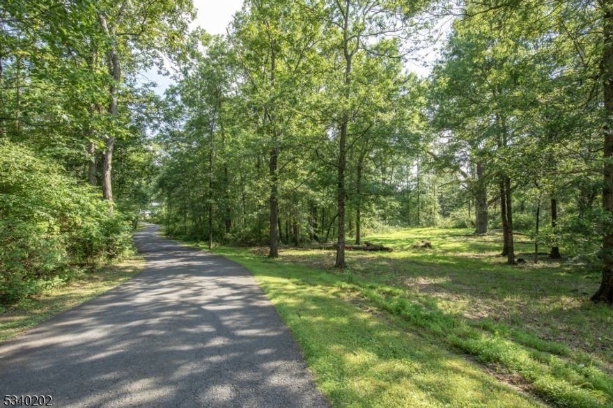 "Great Oak"  A stunning 9.03 Acre lot of mostly open land characterized by forest at the rear. The property features an ancient oak tree and provides a magnificent backdrop for a custom new home. Singing Wood Farm is a timeless  community that affirms the enduring legacy of New Vernon in rural Harding Township.  Situated along a country road, this significant offering represents one of the better remaining parcels of buildable acreage in the township.Characterized by serene rural landscapes and enveloped by inspirational natural beauty, Singing Wood Farm presents an essential collection of exceptional residential locations set amid lush, picturesque backdrops. Convenient to public and private schools, golf courses, equestrian facilities, public transportation, Morristown with its numerous restaurants and cultural activities, The Mall at Short Hills and Newark Liberty International Airport.  Properties are subject to architectural design guidelines, which are for the benefit of each and every land owner. Buyer responsible for rollback taxes. Mailing address is Morristown 07960.