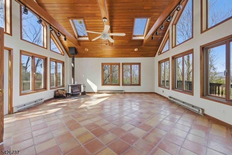 Enjoy beautiful views of the Delaware Water Gap from this home, offering a setting that's hard to replicate- perfect for those who can see the beauty & potential in this home.The expansive great room is the highlight of this home, featuring vaulted wood ceilings, skylights, exposed beams, and walls of windows that fill the space with natural light. Step out onto the front balcony to take in the peaceful, panoramic countryside views. The kitchen shows signs of updating w/oak cabinetry, ss appl, granite countertops & tile flooring. The living room offers a touch of that vintage 60's vibe with built-ins, while the views continue from the front window. An oversized rear deck extends into a backyard that once offered a charming park like setting, where flowers are just beginning to peek through, offering a glimpse of what it can become again w/a little vision & care. While the home is in need of repairs, it offers tremendous potential for the right buyer to restore and make it their own. CASH or RENOVATION TYPE MORTAGES ONLY! Home is being sold strictly "as is" as part of an estate sale- no repairs or credits will be provided. Please note that this home is priced accordingly for its condtion and needed updates. The home is ideally located near the Delaware River for recreational fun, and just minutes to Rt 80 for easy commuting. If you've been looking for a home with views, character, and the opportunity to create something special, this may be the one worth bringing back to life.