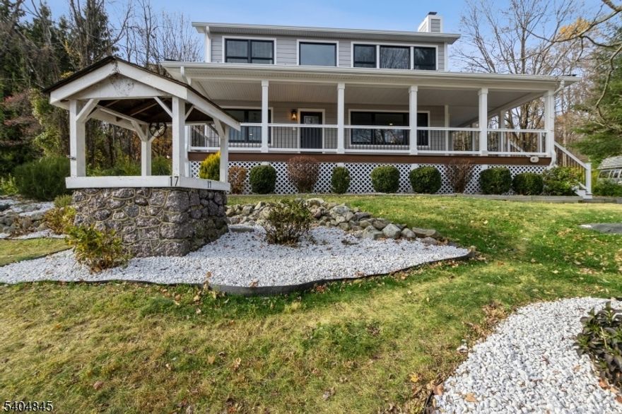 Beautifully updated Colonial w/ modern finishes & open layout, features rich hardwood floors, large windows for plenty of sunlight, elegant crown molding & trim details, & deck overlooking the private backyard, lovely landscaping & brand new pool. Located in Montville Township w/ Boonton mailing address. In the top rated Montville school system. Beyond the wrap-around front porch, the living space flows from the large living room w/ a wood-burning fireplace to the family room & a sunlit formal dining room w/ windows all around. A wide arched doorway brings you into the state-of-the-art kitchen equipped w/ quartz counters, tile backsplash, stainless steel appliances, a breakfast bar, generous cabinetry & full pantry closet. Off the kitchen is a convenient laundry room & a powder room. A doorway to the deck brings you outside to enjoy peaceful privacy in the perfect setting for cookouts, relaxing & entertaining. The second floor has a large primary bedroom suite featuring a vaulted ceiling, a picture window w/ a panoramic view of the countryside, a nice yard w/ a new pool, huge walk-in closet & ensuite bathroom w/ an oversized glass shower. Two additional bedrooms share a full bathroom w/ a dual-sink vanity. To top it all off, a sprawling finished basement offers loads of storage & recreation space. There is also a detached garage & a long driveway for extra parking. Close to major highways, transportation, shopping, parks, schools, & places of worship.