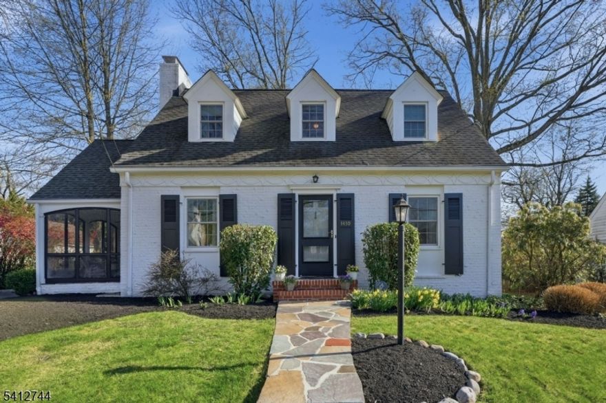 This inviting Colonial Cape offers classic charm from the start, with its brick front and staggered wooden shingles for maximum curb appeal. The main level includes a spacious living room with a cozy fireplace, a formal dining room for gatherings, and an eat-in kitchen with a pantry, along with a handy powder room and a sunporch that brings in great natural light. Wood floors, Pella windows, central air, and an attached two-car garage add to the home's practicality. The second floor features three generously sized bedrooms and two full baths, including a primary suite with two closets and a full bathroom; another bedroom includes an extra room ideal for a home office, play space, or walk-in closet, and the third bedroom also offers a large closet. The finished lower level adds even more usable space with a recreation room and a large area for laundry, utilities, and storage. Outside, the backyard is designed for relaxing and entertaining, with a custom patio, Belgian block accents, a garden shed, and thoughtful landscaping perfect for outdoor dining and barbecues. Located near the Sleepy Hollow section and close to the Netherwood and Plainfield train stations, the home offers a nice balance of neighborhood charm and commuter-friendly convenience.