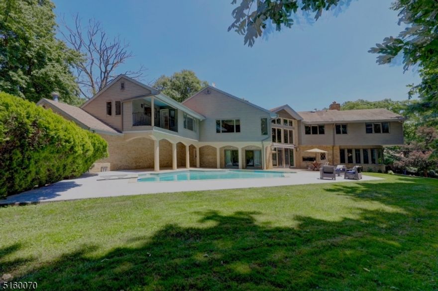 This Stunning custom-built  5 bedroom, 5.5 bathroom contemporary home has a spacious and tasteful aesthetic. Approximately 7000 sq ft of living space, an in-ground swimming pool, and a sprawling 8 car garage is spread over an acre of land in a quiet cul-de-sac with only 9 homes on the block. Immaculately maintained by the original owners, the first floor features a grand entry foyer, carved double doors, FLR leads to a FDR and sun filled EIK. The stunning great room with floor to ceiling stone FP, glass windows and French doors leading to the patio. Multiple entry and exit doors in all directions provides convenience. Kitchen with a huge center island complete with plenty of storage, fully functional appliances, double cooktops and more. The guest bedroom can also be used as a home office and has a separate entrance door for privacy. On to the second level, the palatial Master suite offers his and hers bathrooms and closets and has a private sitting area overlooking the beautiful backyard pool.  An open loft area  with a FP. 3 more bedrooms on this level with their own bathrooms, spacious closets and storage. The massive unfinished basement offers the potential to make - a gym, media room, wine cellar or a game room.  Close to Route 208 & only 20 miles from NYC.  Over 400 acres of park lands, lakes, ponds  with exceptional schools, private social clubs, and the 2nd lowest tax rates in Bergen County. It checks all the boxes as a haven to live, play, work and grow.