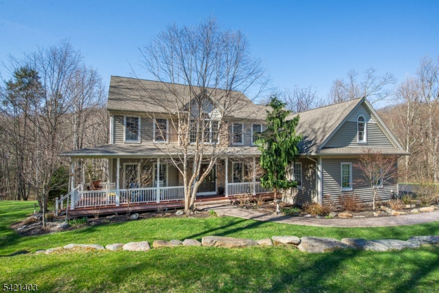 Experience the perfect blend of sophisticated design and rural tranquility. This stunning custom Colonial, built in 2004 and meticulously upgraded since 2013, sits proudly on 5 acres on a quiet cul-de-sac street. Start your mornings on the charming lemonade porch before entering a grand two-story foyer bathed in natural light.The heart of the home is a Gourmet Kitchen designed for the serious chef, featuring granite countertops, a center island with gas cooktop, double ovens, and two lighted pantries +separate dining space with access to deck. The adjacent Great Room impresses with a wall of windows & deck access, soaring cathedral ceilings and a cozy woodstove perfect for chilly evenings (we'll even include the firewood). Retreat to a massive primary BR suite, complete with a sitting room/office, a walk-in closet/dressing room + adjacent bonus space currently used for storage.  A partially finished walk-out basement currently used as work out space will take the pressure off driving to the gym + full bath could convert this space to future in-law suite with the added unfinished space & private entry;  this home offers more space than you ever thought possible.Outside, your private deck overlooks a lush backyard that rolls down to a serene property-edge stream, the perfect getaway exists right on your own deck.  The 3 car garage is conveniently located just off of the kitchen. 1 year Home Warranty included!