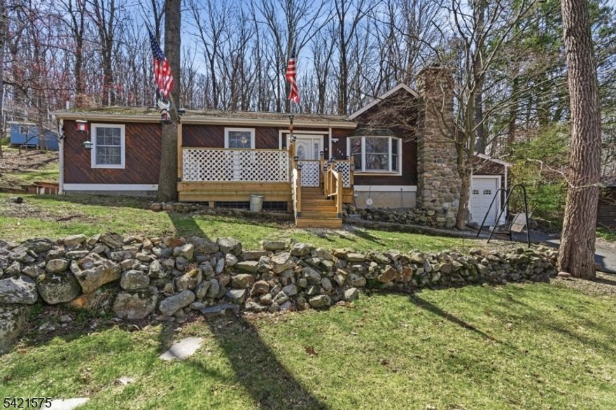 Welcome to this charming Lake Mohawk ranch, ideally situated on a rare double lot with seasonal lake views from the front deck and picture window. The property offers exceptional outdoor living with a rear deck and a multi-tiered backyard, providing versatile spaces for entertaining or quiet relaxation. The home features three bedrooms and two full baths, highlighted by a living room with cathedral ceilings and a fieldstone fireplace with a wood-burning insert. Spacious bedrooms provide flexibility for guest accommodations or a home office. Residents enjoy access to Lake Mohawk's desirable amenities, including private beaches, a scenic boardwalk, and a variety of restaurants and shops that enhance the community's relaxed lifestyle. Yard Tools and Gasoline powered Generator will remain.