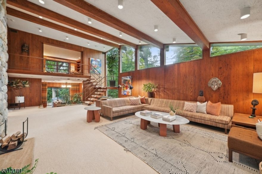 This one-of-a-kind Mid-Century Modern Ranch is unlike anything you've seen! Nestled on a quiet cul-de-sac in the desirable Montrose section of South Orange, this home sits on over half an acre of private, beautifully landscaped grounds. From the moment you step into the travertine entryway, you'll feel the unique character and style of this home. The wide hallway opens into a living room with a double-sided stone fireplace and large picture window framing the stunning grounds. The great room impresses with soaring ceilings, floor-to-ceiling windows, and another stone fireplace. A few steps down is the cozy den with access to a huge stone patio and a sprawling yard. An open staircase leads to the library loft with built-ins and an en-suite bath. The new gourmet eat-in kitchen features Sub-Zero and Wolf appliances, marble countertops, and skylights, filling the space with natural light. The spacious dining room is perfect for entertaining with views of the lush yard. The bedroom wing includes a luxurious primary suite with two baths and ample closet space, plus three more bedrooms and a hall bath. The lower level offers a recreation room, gym, additional bedroom, workshop, wine cellar, and direct access to the oversized 2-car garage. This private oasis with a large slate patio is ideal for outdoor gatherings. New tax assessment for S. Orange for 2024 will be $34,799. Please confirm with Tax Assessor. Chimney, fireplaces and flues are in "As Is" condition.