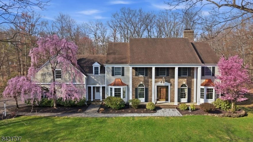 Set on a beautifully manicured property in one of Bridgewater's most sought-after enclaves, this distinguished estate embodies timeless sophistication and refined living. A stately facade framed by mature trees and seasonal blooms creates an unforgettable first impression, blending classic architecture with serene natural surroundings. Inside, graciously scaled interiors are designed for both elegant entertaining and everyday comfort. The home features five spacious bedrooms, including a private guest suite ideal for extended stays or multigenerational living. Two fireplaces anchor the living spaces with warmth and ambiance, offering inviting settings for intimate gatherings. The fully finished lower level with two separate entrances presents exceptional flexibility, perfect for a private retreat, recreation space, or potential guest quarters. A 3-car garage complements the home with both convenience and ample storage. Thoughtfully designed and impeccably maintained, this residence offers a rare opportunity to own a sophisticated estate that seamlessly balances luxury, privacy, and functionality all within close proximity to Bridgewater's premier amenities, commuting routes, and top-rated schools.