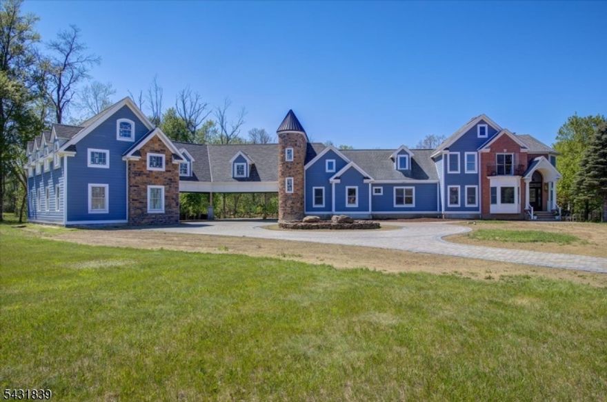 Tucked at the end of a private cul-de-sac on 4.5 acres, this exceptional residence offers true seclusion with a tranquil river running through the backyard. Enjoy the perfect balance of privacy and convenience, just 7 minutes to Route 80 and approximately one hour to Manhattan. Thoughtfully expanded with a second-floor addition and a partially finished basement, the home provides additional potential living space of up to 1,926 square feet. A brand-new 4 car garage features a tall bay designed to accommodate a car lift, ideal for automotive enthusiasts. Inside, timeless elegance is evident throughout with engineered hardwood floors, crown molding, and custom accent walls. The fully updated kitchen showcases stainless steel appliances, luxurious Cambria quartz countertops with brass veining, a generous center island, and sophisticated two-tone cabinetry. The primary suite serves as a private retreat, complete with a freestanding soaking tub, dual shower heads, and striking tile work. The basement is equally impressive, offering a home theater, dedicated gym, and brand-new HVAC systems. Additional highlights include smart thermostats, a walk-out deck, and a serene backyard oasis with a pool and outdoor fire pit. This is more than a home, it's a rare opportunity to enjoy luxury, nature, and modern convenience in one extraordinary setting.