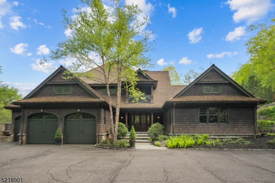 Escape to a private oasis on over 6 acres of lush woodlands in this stunning, one-of-a-kind custom home built by one of New Jersey's top builders, Polo Master Builders. Roughly 9,970 SqFt, this luxurious mansion is custom-designed by renowned master carpenter Jack Wright. The property boasts the finest amenities, including a heated in-ground pool w/ soothing waterfall, jacuzzi, lodge-style bar, theater, gym & sauna. Smart home automation allows you to control every aspect of the home w/ ease, from the lighting to temperature. The sun-drenched main level highlights detail-work like quarter-sawn Oak floors, a herringbone fireplace, a Chef's kitchen w/ a breakfast nook & pantry, soaring family room w/ stone fireplace, a gorgeous master suite w/ a tranquil porch, & a rich Oak-clad Study. The second floor features three additional bedrooms, a full bathroom, a sitting area, & access to a walk-up, partially finished attic w/ ample storage space. This resort-like home is perfect for those who enjoy entertaining, relaxing, & indulging in luxurious amenities. The heated pool & jacuzzi provide a serene & refreshing environment to unwind, while the game room & theater are perfect for hosting guests. The radiant living spaces create a warm & inviting ambiance that's perfect for everyday living. Minutes to Morristown, public transportation, major highways, & award-winning schools, this property offers the ultimate combination of privacy & convenience.