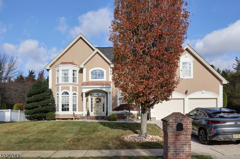 Discover the rare Tulrusotrac model home that combines elegance and functionality. This 4-bedroom, 4.5-bathroom property is truly a gem. From the moment you arrive, the stucco exterior and elegant paver driveway create an inviting curb appeal, complemented by a brand-new front door. Step inside to find gleaming hardwood floors throughout, an office/den, a formal dining room, and a two-story living room with a gas fireplace that adds warmth and charm. The updated kitchen is a chef's delight, featuring a waterfall center island, stainless steel appliances, and soft-close cabinetry. Adjacent to the kitchen is a cozy sitting area with private access to a beautifully pavered backyard, which backs to serene wooded views for ultimate privacy. Each bedroom is generously sized, including a princess suite and a luxurious primary bedroom with a spa-like ensuite and a spacious walk-in closet.The finished basement offers endless possibilities for entertainment, with bonus rooms and recessed lighting throughout. Additional features include ceiling fans, a grand center colonial design, and an impressive entrance foyer. This home is a must-see! Schedule your tour today and experience the perfect blend of comfort and sophistication.