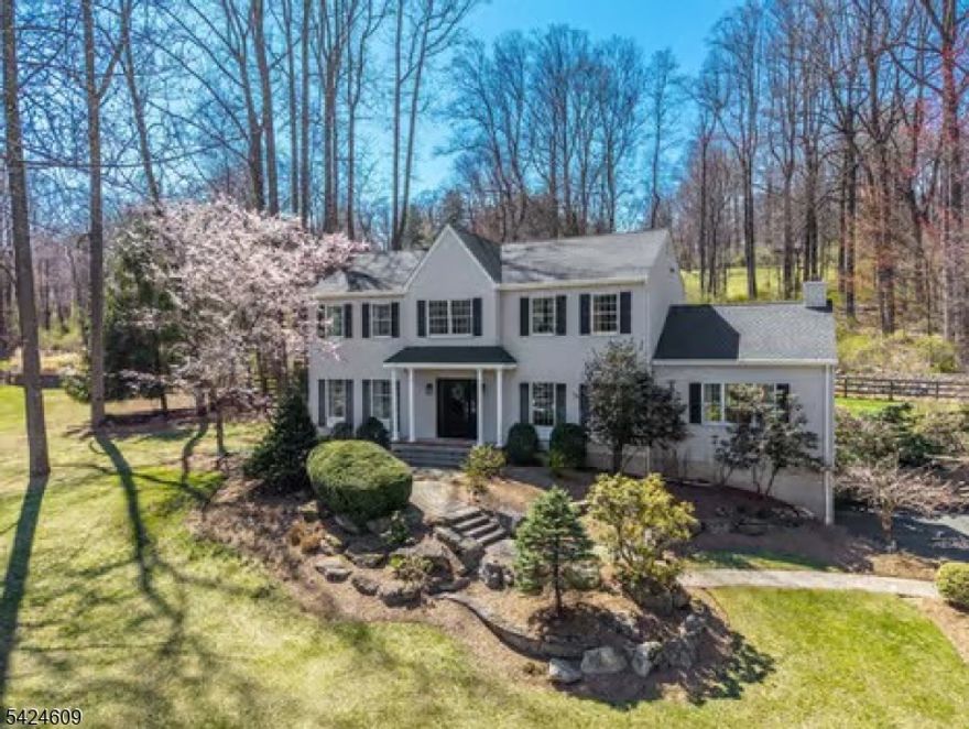 Discover the perfect blend of privacy, space, and comfort in this beautifully updated Colonial, ideally situated at the end of a quiet cul-de-sac in desirable Hickory Ridge. Surrounded by scenic views year-round, this home delivers both tranquility and convenience.Step inside to a thoughtfully designed layout featuring a welcoming foyer, elegant formal living and dining rooms, and a stunning renovated eat-in kitchen built for everyday living and entertaining. Highlights include custom cabinetry, a built-in refrigerator/freezer, and newer high-end ss appliances. Sliding doors lead to a spacious deck, while the eat-in area flows seamlessly into a large family room with a classic wood-burning fireplace.Main level also offers a private den perfect for remote work plus a powder room and convenient laundry area. Upstairs, the primary suite features a walk-in closet and updated bath, complemented by three generously sized bedrooms and a refreshed hall bath plus pull-down attic access.The finished lower-level living with a recreation room, wet bar with new refrigerator, dedicated gym, mudroom, utility/storage room, and direct garage access.Enjoy low-maintenance living with a newer roof and vinyl siding, plus a large, level fenced backyard designed for relaxation and entertaining complete with an oversized Trex deck, retractable awning, storage shed, and additional seating area.Hunterdon County schools, shopping, 2 mi fr Rt 78 X12 & 3 nearby state parks. Taxes for 2025: $14,551.
