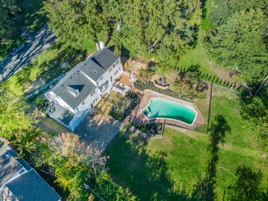 STUNNING COMPLETELY RENOVATED 6-BEDROOM COLONIAL ON HUGE LOT W/OUTDOOR POOL IN UPPER MONTCLAIR-CLOSE TO NYC DIRECT TRAIN.  Gorgeously curated state of the art kitchen w/streamlined look has Bertazzoni 6-burner stove, Bertazzoni double-doored fridge w/custom white cabinet paneling, Bosch dishwasher w/custom white paneling, huge white quartz center island topped w/white pendant lighting  & gold accents, plenty of cabinetry w/gold hardware incl pantry & tons of windows-bringing the outdoors inside!  Loads of sunlight  & what a view! Approx 1/2 acre flat bkyrd w/pool & plenty of space for entertainment or dinner on the deck.  Showpiece living room has floor to ceiling built-ins & wood-burning fireplace. 2nd flr boasts four nice-sized bedrooms + newly renovated main bath.  Gracious, sunfilled generous primary bdrm on 3rd lvl includes skylight, sitting area w/a wall of windows overlooking bkyrd & pool.  Primary bath is instagram-ready!  SO CHIC!  Freestanding egg-shaped soaking tub, double sinks, skylight, glass-doored shower, elegant floor tiles & fixtures. Not done! Lwr level is perfect fam rm for watching your favorite Netflix movies + there's a convenient full bath attached.  MORE room in fully fin bsmt...can be playroom, pool room, guest room, endless possibilities.  Gas heat, AC, HW flrs, 2-car garage. Enjoy 3 parks all less than a 1/2 mile away...where you will find playgrounds, dog parks, rose gardens, running & walking trails & in the summer, fireworks & outdoor concerts.