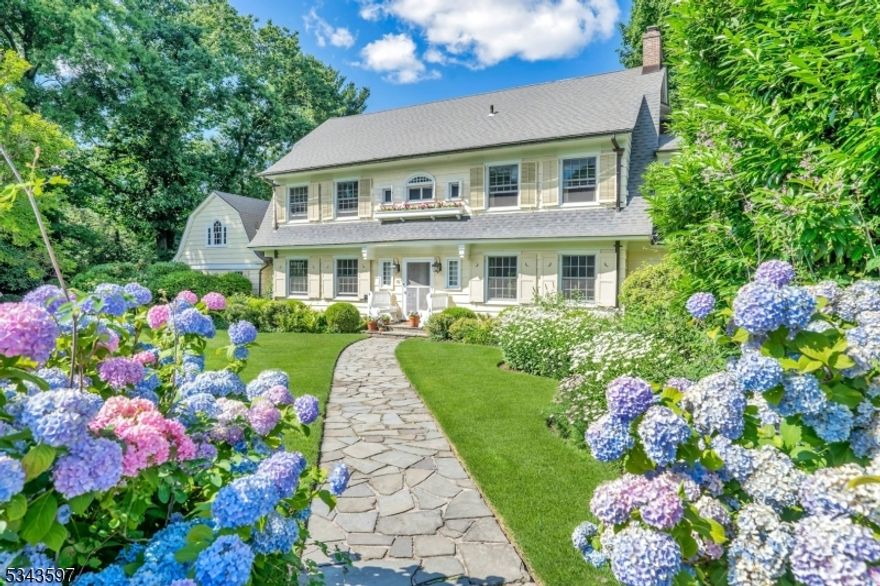 You'll be enchanted- like most everyone else in Montclair- by this Nantucket-like retreat in the town's most sought-after neighborhood: Erwin Park. A delightful blend of original charm and open, airy spaces, this home exudes relaxed elegance. Ideally located just 3 blocks from the NYC Midtown Direct train, Watchung Plaza shops, and every level of school. From the moment you pass through the white picket fence and garden gate, you'll be captivated. A grand floating staircase greets you, leading to light-filled living & dining rooms, perfect for entertaining. The oak-paneled family room is cozy for movie nights or quiet reading by the fire. The glamorous sunroom with its hand-stenciled floor offers a front row to the backyard splendor .The updated chef's kitchen with center island, breakfast  room & pantry is spacious and cheery. A new custom laundry/mudroom adds convenience. Enjoy the high-ceilinged rec room-perfect for play, WFH or exercise. The serene primary suite boasts a renovated bath and spacious dressing room w/ original built-ins. Two generous en-suite bedrooms and a beautifully designed office complete the picture. The bright 3rd fl features 3 more bedrooms, full bath & loads of storage. The fenced backyard is a private oasis with a heated gunite saltwater pool, sprawling lawn, stunning landscaping, vegetable beds, flowers galore, & a charming treehouse! An expansive bluestone patio & veranda are perfect for al fresco dining.16 Erwin Park is a true gem. Welcome home!