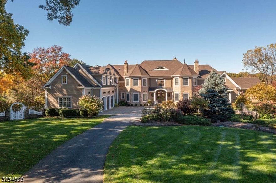 This timeless custom-built estate is nestled into a private 3.28-acre setting edged by woodlands and open lawns. Approached by a winding drive, this stone and stucco home is surrounded by preserved acreage for additional privacy. Three finished levels of living space measuring over 7,900 square-feet offer six bedrooms, five full baths, two powder rooms, plus an attached four-car garage. There is a beautiful first floor primary suite with a sitting room and 3 walk-in customized closets. The second floor enjoys 5 additional bedrooms, a home theatre and a large office / bonus room. The walk out lower level has a spacious gym with a massage room. There is an abundance of unfinished space here ready for custom finishing by the next owner if desired.  Manicured grounds feature thoughtful landscaping, colorful perennial gardens, landscape lighting, a charming greenhouse, firepit area, plus stone terraces, walls and walkways. Truly exceptional, this residence is beautifully maintained throughout. The residence enjoys public water  and there is a well for the sprinkler system. Financial Reference letter required.