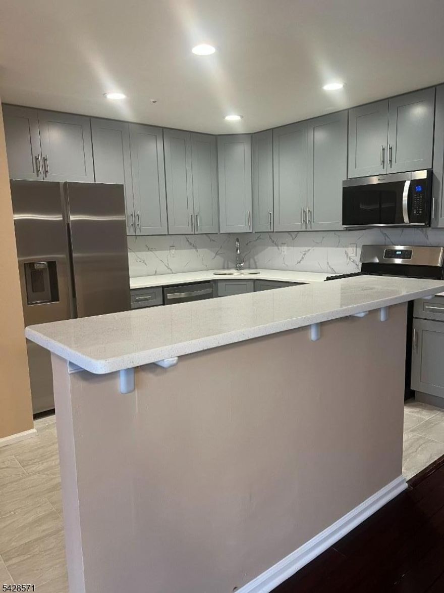 Gorgeous completely renovated 2 bedroom 1st floor condo with garage and storage room in basement. brand new kitchen with 42 inch cabinet, corian countertop, stainless stain appliances, center island, hardwood floors, ceramic tiles, new bathroom, double sink vanity, club house with swimming pool, will not last!!