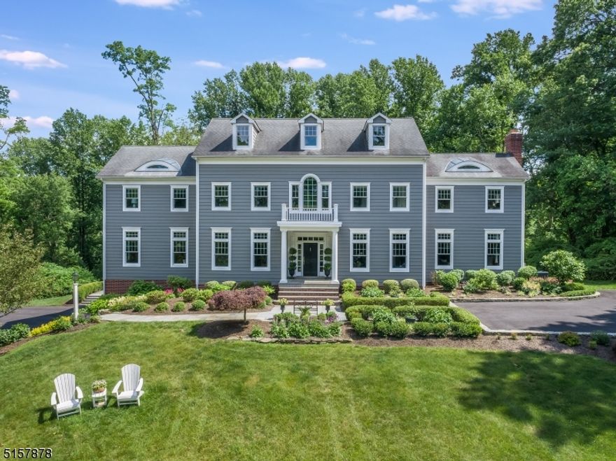 Nestled on 10+ acres, this colonial is brimming with curb appeal from its classic architecture and lushly landscaped grounds. The same charm seen outside flows into the home's interior, where hardwood floors are a fine design element flowing from one room to the next, each space designed with character and exquisite details. Natural light cascades through abundant windows in the sun-filled first floor which blends formal and casual living with ease.  The grand foyer welcomes you to this stunning surroundings for entertaining. The flow continues to the kitchen with a wealth of sparkling white cabinetry topped in quartz, a breakfast area overlooking the impressive property, and French doors to the spectacular patio and yard. Situated off of this inviting space is the family room, not to be missed is the fabulous sun room and the home office with expertly crafted millwork.  Upstairs, the primary suite is a private retreat with a roomy bedroom, a spa-like bath, and a walk in closet.  Four additional bedrooms, with hardwood floors, two full baths, and a second home office complete the second floor.  The outdoor space is breathtaking.  Surrounded by tall trees, the private grounds offer sweeping lawns, meticulous landscaping, and perennial gardens.  The gorgeous, raised bluestone patio and pool offer the perfect venues to relax and enjoy tranquility or host a festive get-together.  This home has it all.