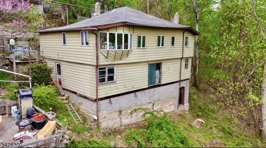 Fixer upper with LAKE VIEWS of Mountain Lake. 3 bed 1 bath in need of complete renovation. Larger than it looks from the street. 2 levels plus basement. 1681 sqft. as per property record card. Sold strictly AS-IS. SELLER WILL NOT MAKE ANY REPAIRS OR GIVE ANY CREDITS. Seller and their affiliates make no representation, warranty, or guarantees regarding any information provided. Buyer(s) to do their own due diligence. Hold Harmless and Proof of Funds req. for showing to be approved. Do not walk on property without signed waiver and confirmed appointment.