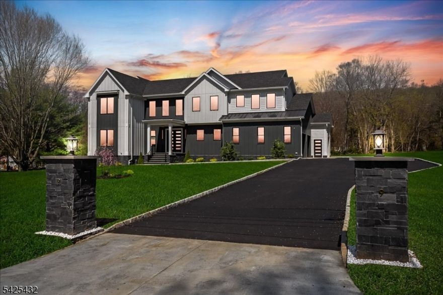 Nestled on a breathtaking private lot in desirable Warren, this extraordinary new construction modern farmhouse offers 6 bedrooms, 6.1 baths, a 3-car garage, and 3 finished levels of beautifully designed living space. Crafted to blend luxury, warmth, and effortless everyday living, this home also offers exceptional convenience for commuters with easy access to major highways, Newark Airport, and NYC.A dramatic 2-story foyer opens to sun-filled living spaces with soaring 10' ceilings, wide-plank white oak floors, and walls of glass overlooking the serene grounds. Just off the foyer, a private first-floor suite with full bath offers the ideal office, guest retreat, or 6th bedroom.The designer kitchen is the heart of the home, featuring a 10' quartz island, hidden walk-in pantry, premium appliances, wine cooler, and quartz backsplash. The dining area opens to a covered porch and expansive composite deck overlooking the private backyard. The stunning great room features a dramatic fireplace wall, illuminated built-ins, custom white oak mantel, and oversized sliding doors for seamless indoor-outdoor living.Upstairs, the luxurious primary suite offers a spa-like bath and separate his-and-hers walk-in closets. Spacious secondary suites and second-floor laundry add comfort and convenience. The finished lower level includes 3 oversized recreation rooms, a custom gym with specialized flooring, future sauna area, full bath, utility room, and extensive storage. Visit our website!