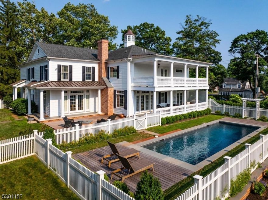 Estate living, in-town location! Experience the pinnacle of architectural excellence infused with Southern charm. This 4+ bedroom colonial, built in 2011, is a modern tribute to the original Dyckman Farm home. Masterfully designed to suit your lifestyle, the versatile floor plan is bound only by your imagination. The two-story foyer provides a gracious welcome, featuring a custom oak staircase and barrel ceilings that segue into the family room where you'll find transomed windows, a masonry fireplace, and coffered ceiling. The state-of-the-art kitchen is truly the heart of this home, with furniture quality cabinetry, a generously sized center island with walnut countertop, dining-room sized breakfast area, and doors to the veranda overlooking the pool. The quintessential keeping room with gas fireplace separates the kitchen and living room. The primary ensuite features volume ceiling, French doors to the veranda with beautiful views, a spa-quality bath, and walk-in closet with island.  Three additional bedrooms plus two baths that includes a second ensuite, plus room-sized laundry room complete this level. The lower level is fully finished with recessed lighting and plank flooring. Step outside to covered veranda with beadboard ceilings on each level, that offer both breathtaking views and easy access to the stunning heated gunite pool with Ipe ground-level decking and bluestone surround. The rebuilt garage/barn features a two-plus car garage, and a charming, expansive loft.