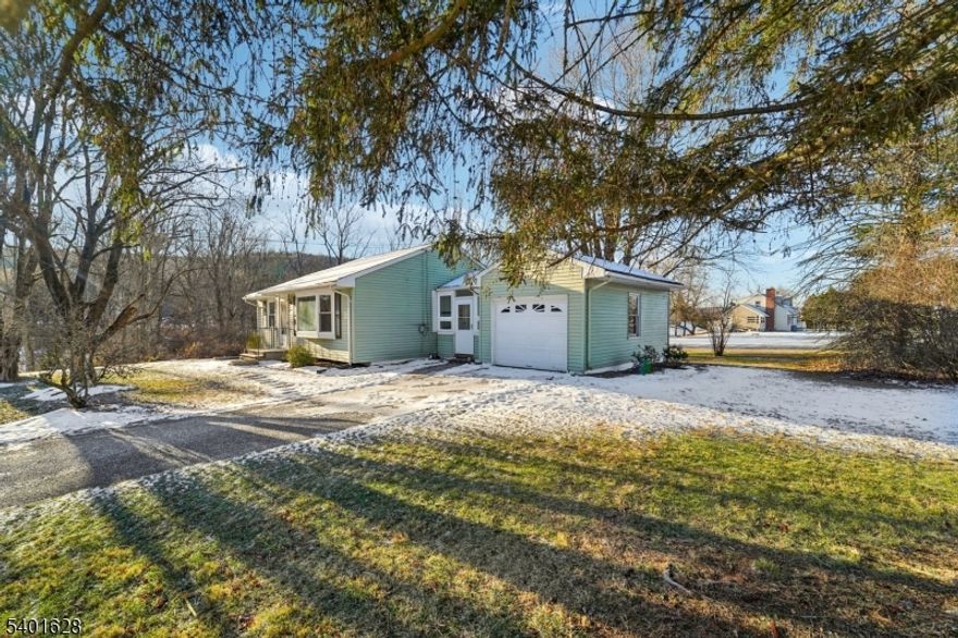 Discover the charm of this beautifully updated ranch nestled in the heart of Lake Tranquility. With hardwood floors throughout, newer windows, and a full basement, this home blends timeless style with modern comfort. The breezeway leads to a convenient 1-car garage, while the flat property offers easy living and outdoor enjoyment. Wake up each day to tranquil views of the lake right across the street, where dramatic sunsets paint the sky in every season. The property also borders a peaceful stream, adding to the natural beauty that surrounds you. Inside, everything has been thoughtfully laid out, 2 bedrooms, guest closet and extra details like a laundry chute make everyday living effortless. Lk Tranquility is more than a neighborhood it's a lifestyle. Residents enjoy four seasons of beauty, optional lake association membership with access to beaches, and a calendar of social events that foster a special sense of community. Whether it's kayaking in summer, crisp autumn walks, or winter gatherings, this welcoming environment makes every day feel like a retreat. This ranch is move-in ready, offering the perfect balance of comfort, convenience, and connection to nature. Don't miss the chance to make this home yours and experience the best of what life has to offer.