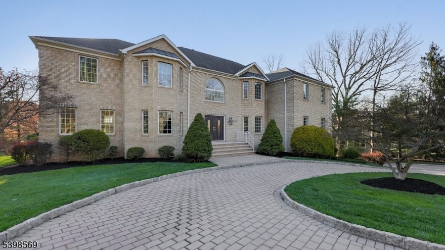 This elegant Colonial residences offers an impressive seven bedroom layout, combining timeless architecture with spacious, light-filled interiors.  A grand foyer welcomes you with soaring ceilings and a stunning lift chandelier, creating a dramatic first impression upon entry.  Hardwood floors extend throughout the home, complemented by abundant windows that flood each room with natural light, enhancing the bright and airy ambiance.  The well-proportioned living spaces provide flexibility for a variety of needs. The second floor primary bedroom offers a private retreat, complete with a separate sitting room and two walk-in closets, providing both comfort and ample storage.  Each additional bedroom is generously sized, offering versatility and space throughout the home.  The finished basement adds even more functional space, featuring a dedicated dance studio - ideal for creative pursuits, fitness, or a variety of recreational users. Step outside to the rear deck, perfect for relaxing or entertaining, overlooking a fenced-in yard that offers both privacy and practicality. Ideally located within walking distance to Watchung Lake, offering opportunities to enjoy the outdoors and scenic surroundings.