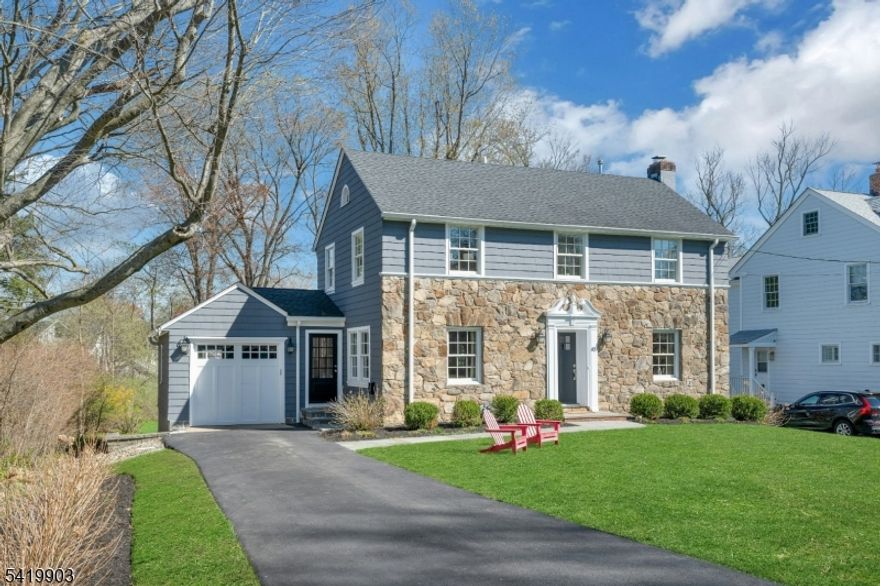 This timeless 3 BR, 2.1 bath Colonial is ideally located on what is widely considered one of the most desirable streets in the Manor Section and in all of Chatham Borough, just blocks to downtown, top rated schools, restaurants, and Midtown Direct trains to NYC, approx .3 miles from the home. A classic center hall layout showcases a natural stone front exterior. Hardwood floors run throughout the first and second levels. The open floor plan is designed for today's living, with a beautifully renovated kitchen featuring quartz countertops, center island, and updated appliances, flowing into the dining area and den. The living room offers a wood burning fireplace, while the den is filled with natural light and opens to the deck. A mudroom with powder room and side entrance from the driveway adds convenience. The second level includes three bedrooms and two full baths, including a primary suite with ensuite bath and closet space, along with an updated hall bath. A walk up attic offers potential. The finished lower level features new luxury vinyl plank flooring and flexible space. Outside, the expansive, level backyard is truly beautiful, set on .43 acres with open lawn and mature trees creating a peaceful, park like setting with room for expansion.Highest and best offers due Tuesday 4/21 at 3:00 PM. Offer Guidelines available in Media.