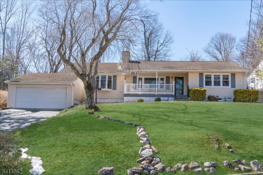 Charming ranch home on half an acre with 2 car garage.  Enjoy the inviting views from the covered front porch.  Private rear deck & patio!  This home is perfect for relaxing and/or entertaining with open floor plan - light & bright  The spacious living room has a fireplace with a wood-burning insert and is open to the dining area with wainscoting and fabulous 2 year old kitchen.  The new cook's kitchen boasts large sink, wood cabinetry, appliances & granite countertops.  2 roomy bedrooms & an updated bath.   An additional room is shown virtually staged as an office and has a picture window with window seat.  Vaulted skylight, central air conditioning, hardwood flooring, recessed lighting and more!  Seneca Lake is a 23 acre private lake located in a quiet neighborhood offering beach & lake access as well as boating & swimming activities.   A wonderful blend of comfort and style in a scenic setting.  Sparta Twp. Schools! Please submit all offers Highest & Best by Wednesday, 3/18/26 - 12noon.