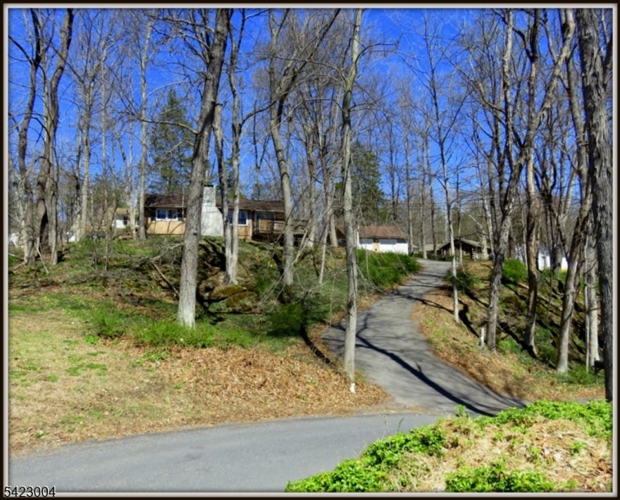 Escape to the Lake on "KILL" Drive  ( Dutch for River) which runs parallel to the PaulinsKILL River. Totally renovated in 2023, with new 150 amp electric service in 2024, recessed lighting, and new flooring.  Cooks will love the Kitchen with new cabinets graced with QUARTZ counters, and newer appliances. The cathedral ceilinged Great Room is warmed by an original feildstone fireplace which was adapted for gas, new roof, new gutters, and windows replaced in 2023, new hotwater heater 2024. Large 2 car garage with storage loft, 2 new garage doors 2025 and an attached dog run. Membership required at Paulinskill Lake, a motorboat lake, with 2  lifeguarded  beaches and a Tennis Court adapted for Piclkleball.