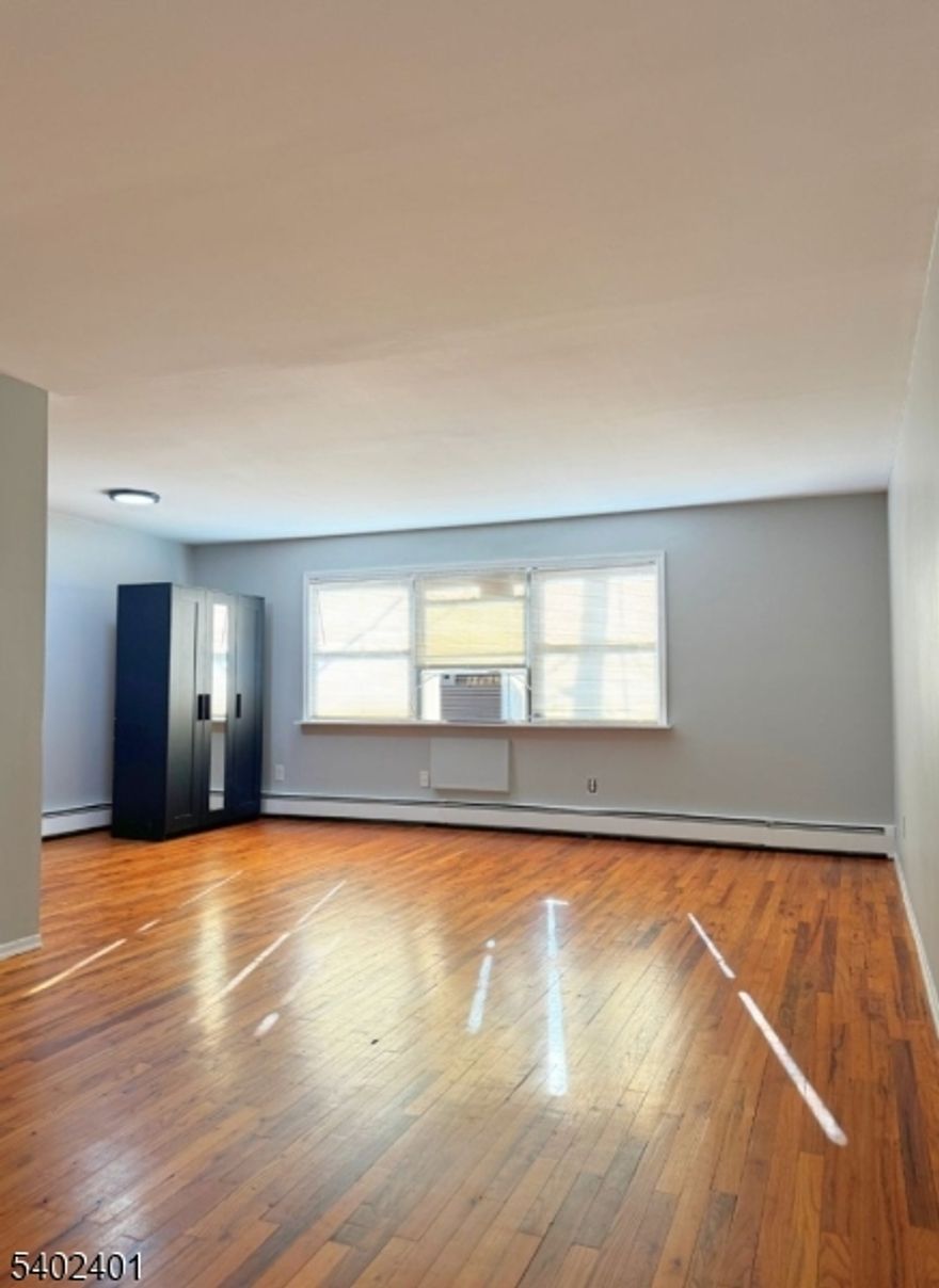 Step into comfort with this charming one-bedroom apartment! Enjoy the timeless beauty of classic hardwood floors and reliable baseboard heating for cozy winters. Beat the summer heat with window AC and wall AC units in the bedroom for ultimate relief! Convenience is key with your dedicated, assigned parking space and on-site shared laundry. A functional living space in a fantastic location?this gem won't last! Schedule your viewing today!