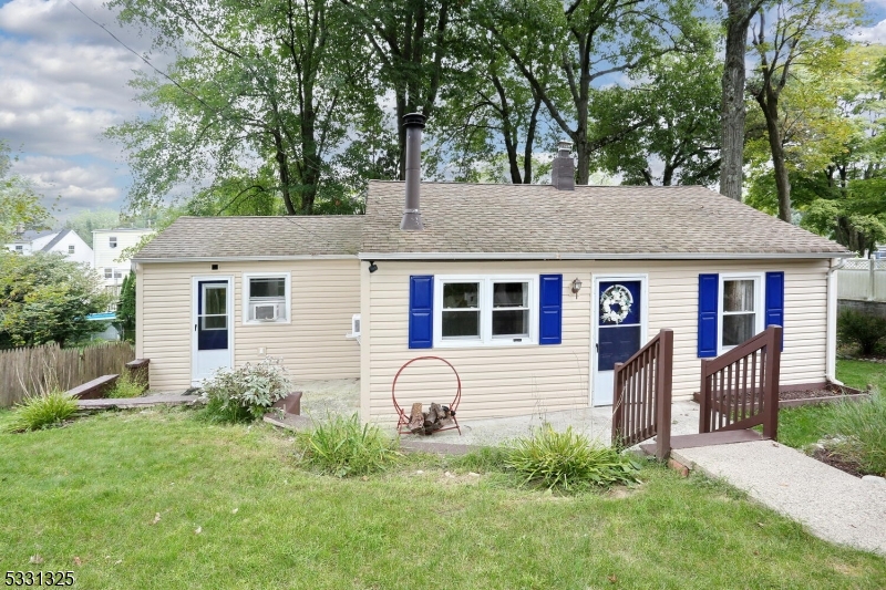 Check out this two bedroom one bathroom lake style ranch in the Skyline Lakes community (membership optional). Brand new roof! Situated on a quiet street, this home is move-in ready. A large eat in kitchen with deck off the back is the hub of this home featuring a tile floor and glass tile backsplace. Doors to the front patio and rear deck make for an easy entertaining flow. The wood-burning, mid-century cone style fireplace in the living room provides ample heat for the house and a cozy ambiance as the fall and winter approach. An office/laundry room is off the living room, conveniently located for one floor living. An updated bathroom and two bedrooms complete this sweet home. Basement access can be found in the rear of the home.