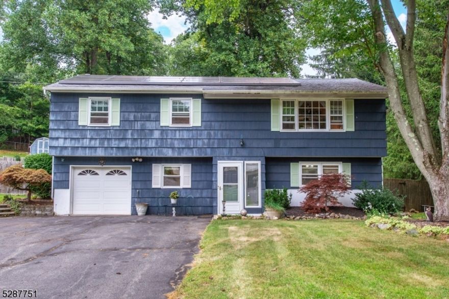 Desirable Alcrest Estates home with deck overlooking large and usable yard. Main floor features living room offering hardwood flooring open to huge eat-in kitchen with sliders to deck, three bedrooms and full bath. Fully finished lower level with full bath and office, access to garage and laundry complete the package. Public utilities, great Mt Olive schools. A few personal touches will make this the perfect home!