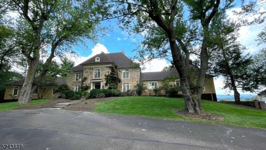 Best View Ever! Enjoy the sunrise and sunset from this fairytale like custom French Chateau designed by renown architect James Timpson and built by the Hazekamp Brothers. This stone/stucco estate stands on top of the hill with the most panoramic view in Mendham. The private lane meanders peacefully through an exceptional portion of Mendham's estate section, pasts a grove of silver maples and ends in a courtyard of circular drive. The 2 story high, circular entrance hall welcomes you into an elegant living room with views to the horizon. The spiral staircase takes you to the second floor with open view to LR and foyer. Maid Quarters has direct staircase to the kitchen. Gourmet Kitchen connects the breakfast area and a big great room with 1 of 4 Wood Burning Fireplaces. Very large master bedroom with large custom built-in closets and Jacuzzi on the other side of the first floor to ensure the privacy. Additional bedroom/bathroom on the 1st floor. Oversized 2 car attached garage. 4 car detached garage with a work room can be easily converted to an outdoor bar and potential cottage house with a 2 car garage. The lotus flowers in the Koi pond adds more zen moments and lots of picture opportunities in your daily life. The major part of the property is deer proofed. New roof. stucco and some interior area are newly updated. Home is SOLD AS IS. SQFT is from tax records.