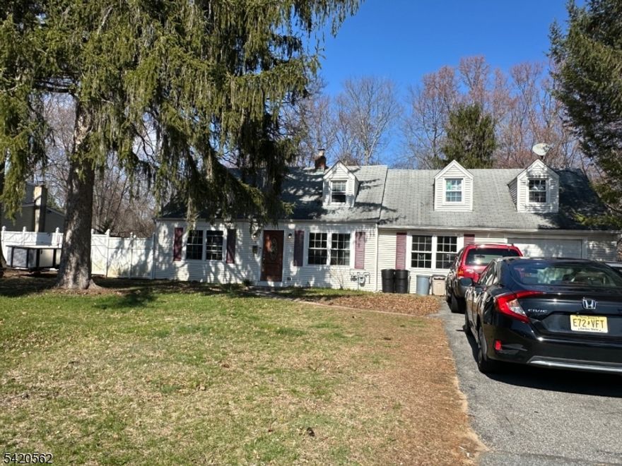 Welcome to this spacious Cape Cod filled with potential. The first floor features a bright living room, two bedrooms (one with a deep walk-in closet) an oversized kitchen with abundant cabinetry, ample counter space, stainless steel appliances and a stylish backsplash. Ceiling fans are found throughout, and the kitchen opens to a cheerful dining area, perfect for entertaining. Laundry is conveniently located on the fist floor and a full updated bath and an enclosed rear sunroom complete the main level.  The second floor offers two additional bedrooms and a large walk-in attic spanning over the dining area and garage, providing endless possibilities for expansion or storage. Situated on a large, level, fenced-in lot. Conveniently located to shopping and highways.  Flood insurance required.