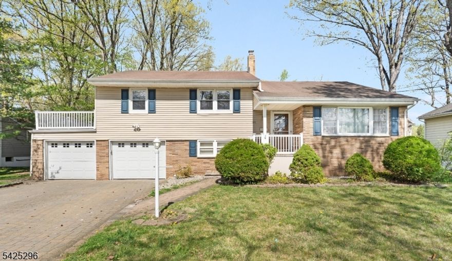 Welcome to this Turn Key 3 Bedroom, 2 1/2 Bath Home nestled on a Tree lined Street in one of Springfield's Tranquil neighborhoods. First floor boasts a gorgeous Kitchen along with a Breakfast bar, Quartz countertops and stainless steel appliances. Spacious living room complete with recessed lighting and gleaming hardwood floors throughout. Enjoy your mornings in a cozy light and bright Sunroom all year round!  Second floor hosts 3 bedrooms including the primary suite with full bath and walk in closet. Ground level features large family room, powder room, oversized laundry room and access to the garage as well as the backyard. Basement level is finished with plenty of storage space, workshop, cedar closet and a wet bar waiting for your finishes touches. Central Air, Hardwood floors, Recessed lighting, Generous yard, Paver stone driveway that fits 4 cars plus 2 Car Oversized garage, Vinyl fence, Whole house fan, Central VAC and ALL of this is a very short walk to the 114 Bus into NYC!!  Make your appointment today!