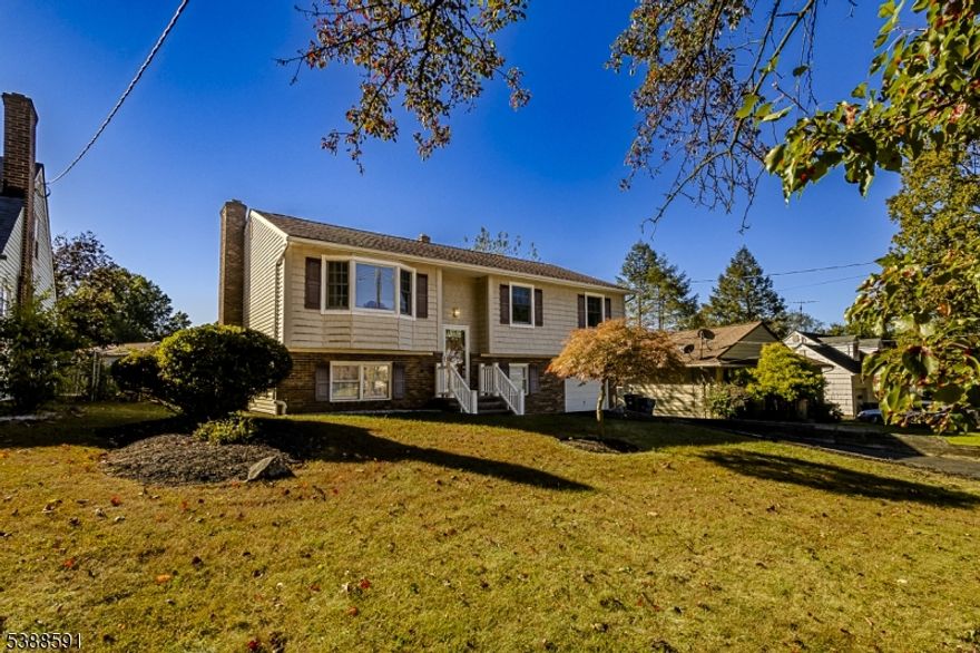 Spacious Bi level home with an updated kitchen and bath, woodburning fireplace in family room, 4 possibly 5 bedrooms, central air and heat and so much more.  Beautiful hardwood floors, attached garage, large deck off the dining room and large patio off the family room on lower level. Roof has solar panels. Show and sell!!!!