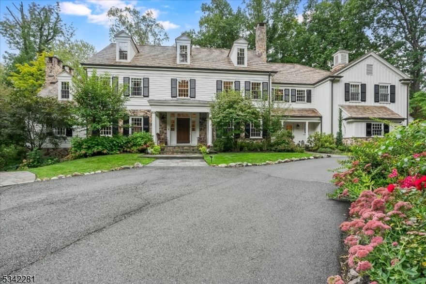 Welcome to 10 Hawthorne Rd, perfectly positioned in the heart of in Essex Fells, NJ- NYC's most luxurious suburb. Located on over 2+acres of private picturesque property, this charming, custom built home offers timeless elegance and designer finishes. Step into a grand two-story foyer as you enter into an over sized eat-in kitchen with open flow to a large family room with a full bar, perfect for entertaining. The first floor also boasts a formal dining room, wet bar and intimate living room, along with a study featuring custom mahogany built ins as well as a mudroom off of the kitchen. The second floor offers a large Primary Suite with a separate sitting room, three massive custom closets, as well as a luxurious bathroom with radiant heat, a jetted tub and steam shower features. The second floor additionally offers four ensuite bedrooms as well as a spacious laundry room. Third level includes an additional bedroom and bathroom as well as plenty of flex space. This is a true entertainer's paradise: Amongst countless amenities, you and your loved ones will enjoy the convenience and luxury of a private gym, rec room, game room, wet bar, music studio and four car garage. Outside, enjoy pristine landscaping in a park-like setting with oversized blue stone patios overlooking a small koi pond, nature path, footbridge and a custom built playhouse. Enjoy this charming town with nationally ranked schools and 25 mile commute to NYC. This stunning masterpiece of a home truly has it all!