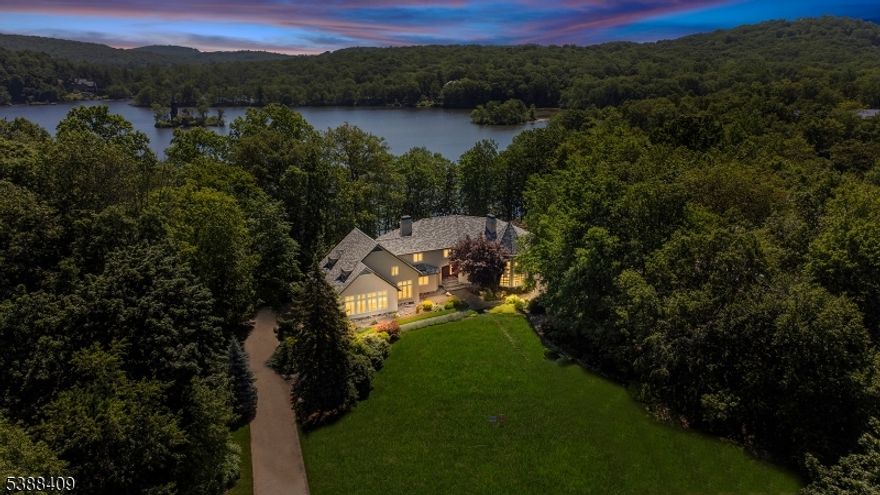 Indulge in lakeside luxury as this exceptional residence sits just 35 miles from Manhattan and offers one of NJ's most desired waterfront experiences. Located on famed West Shore Dr in Smoke Rise, Kinnelon's renowned gated community, this residence provides an ever-evolving panorama of stunning lake views visible from nearly every room. Live every day like a tranquil getaway, as the home boasts a sprawling waterside pool area complete with patios, an outdoor kitchen, and gated access to lake/trails. Inside, soaring ceilings and walls of glass highlight the expansive floor plan, offering exquisite living areas over three floors. Within this sought-after gated enclave, you'll find one of New Jersey's liveliest social scenes, with an array of clubs, dining, a beach, tennis club, sports bar, fishing, swimming, 24/7 gated security, and more. Embrace this exceptional opportunity to own a breathtaking home in an unparalleled setting! Schedule your private tour today.
