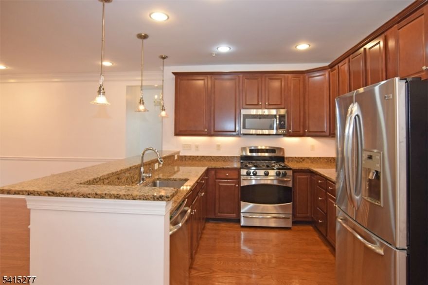 Private end unit with balcony, 2 bedrooms, office AND two (2) assigned indoor parking spaces with locked storage. 17x10 Kitchen includes granite countertops, 42" cherry cabinets, stainless sink, 5 burner gas stove, microwave, dishwasher and refrigerator. LR/DR combination with hardwood floor is 26x16. Large 15x12 office with built-in bookshelves. 20x16 MBR has 2 closets including a 6x6 walk-in plus 10x9 ceramic tiled bath with shower over tub. The 2nd bedroom is 11x11 with wall to wall carpet.