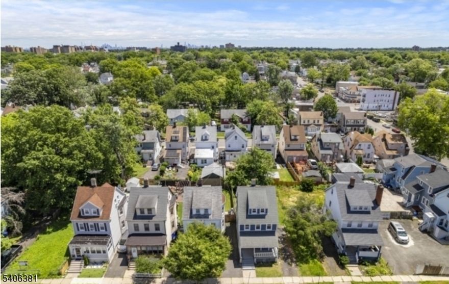 "Beautifully maintained colonial-style single-family home on a quiet residential street in East Orange. Renovated in 2022, this home offers three levels of finished living space with 5 spacious bedrooms and 1.5 bathrooms. Features include an updated kitchen, upgraded electrical and plumbing, recessed lighting, hardwood floors, and attractive blue siding. The interior layout includes a welcoming foyer, sun-filled living room with bay window, bright dining area, and open kitchen. Enjoy a charming front porch, back deck, large backyard, and a driveway that fits up to 4 cars, with convenient access to NYC by bus or train.