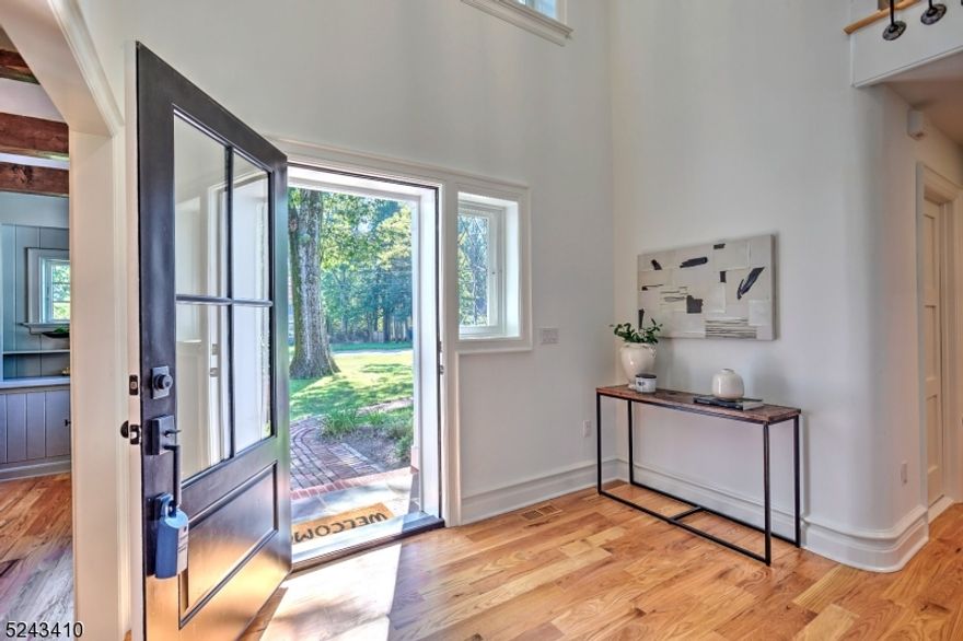 Newly renovated 5 bedroom 5 1/2 bath home features an authentic 1930s masonry facade meticulously blended with the modern technology to create a true one-of-a-kind American classic. Close attention to detail is revealed in the double-height foyer, where the original restored circular staircase with an open second floor mezzanine is edged in original bronze railings.This grand entrance leads to a sunken living room with exposed wood beams & built-in cabinets. A south-facing dining room is flooded with natural light from multiple windows; it links the living room to an open plan island kitchen/great room in the rear of the house. This eat-in kitchen features a giant walk-in pantry. The breakfast area hosts a brick fireplace & double sliding glass doors to a private covered porch & backyard patio. The generously-proportioned great room has soaring ceilings & three walls of windows for sunlight throughout the day. In the main upper foyer, a staircase ascends to two rooms on the 3rd floor providing work-from-home areas or playroom-plenty of space on this level, where large windows offer natural light. The lower level has two generous rooms, one with a wood-burning fireplace. Storage areas & future opportunities for a wine cellar or powder room are options on this level that's ideal for recreation/gym. The utility area has storage & access to the garage without having to enter the main home. Situated on a park-like property with mature trees includes a large garden storage building