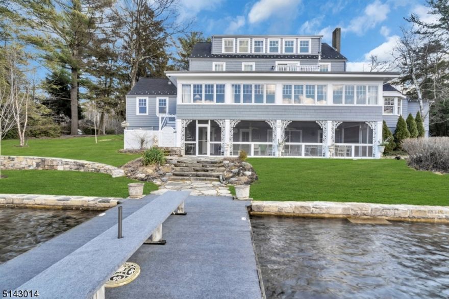 Very seldom does a lakefront property such as this come on the market.  Originally owned and operated as Shawger's Lake End Hotel until 1957 when sold and converted to a single family residence, this iconic landmark is rich in history and offers exceptionally spacious living accommodations.  Located in bucolic Lake End Corporation at Green Pond, this historic home is in excellent condition with many vintage details intact as well as thoughtful renovations to the original structure.  With 4 full levels of finished living space, 4+ bedrooms (up to 7 rooms for sleeping) and 4 1/2 baths, this home is ready to welcome friends. Wall to wall built in book shelves with library ladder flank an entire wall of the Great Room while the vintage "bar room"  is sure to be everyone's favorite place to gather. The newer kitchen boasts custom inset cabinetry with top of the line appliances, radiant heated floors and a dining area with cozy fireplace and built in seating overlooking the lake. An adjoining butler's pantry, or salad kitchen as it was referred to when it was still a hotel, makes entertaining a delight.  A spacious 3 car detached heated garage with overhead loft offers potential for a professional office, crafter or hobbyist. There are 2 year round docks at the edge of the sprawling yard which add to the enjoyment and complete the picture of this truly magnificent property.