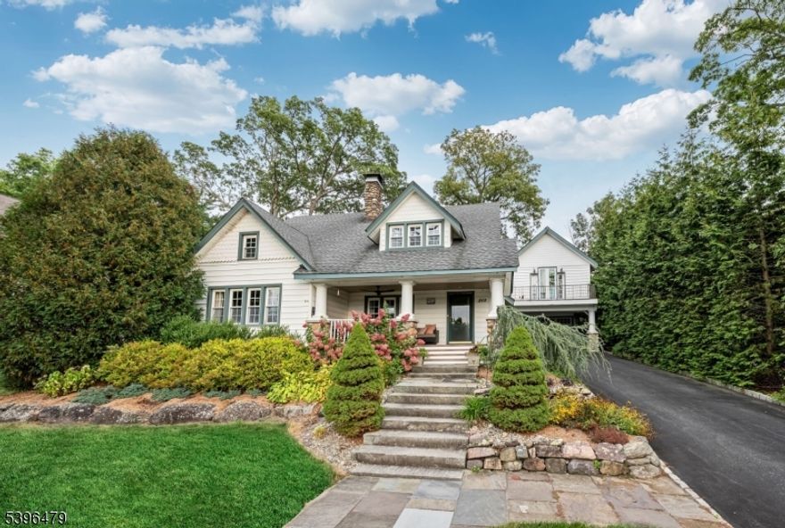 Picturesque, Perfect, & Truly Special! This storybook 4-bedroom home is filled with character, charm, & stunning craftsmanship inside & out. Set gracefully up from the road, its glorious stone exterior & peaceful lake views welcome you from the start. Follow the stone walkway to the inviting front porch & step inside to discover a sun-drenched living room with a striking stone fireplace. A bright breakfast room with built-ins opens to the beautifully updated kitchen, rich in detail & style, leading out to a covered patio with an outdoor fireplace, Koi pond & lovely landscaping-an entertainer's dream! The main floor continues with a formal dining room featuring a charming window seat & built-in cabinetry, a private study, spacious family room & 2 full baths. Upstairs you'll find 4 bedrooms and another full bath, while the basement offers laundry & storage. A detached 2 car garage adds even more versatility with a private studio/office/workshop above, complete with a balcony & separate entrance. Rich in detail & thoughtful updates, this home features wood floors, recessed lighting, newer windows, updated baths & architectural nooks throughout. This property includes a private dock with gazebo. As an active member of the Awosting Association, residents enjoy access to tennis courts, beach, clubhouse, boathouse & park-a true "staycation lifestyle. This one-of-a-kind property is brimming with warmth, beauty, & timeless appeal-a perfect blend of elegance, comfort & lakeside living!