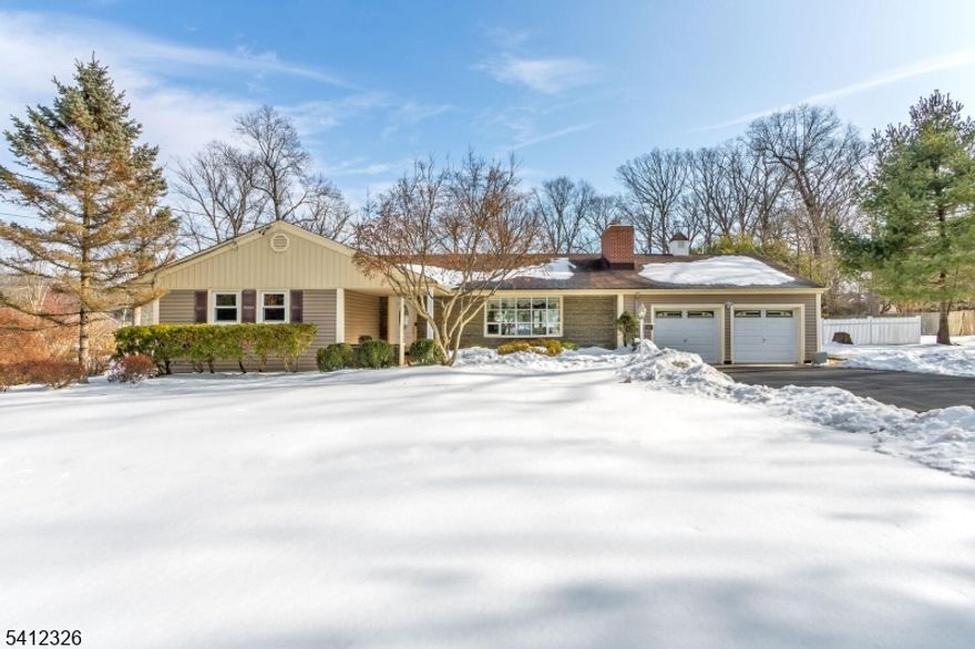 Welcome to this beautifully maintained, expanded Ranch set on an exceptional 1.42-acre property, offering space, privacy, and thoughtful updates throughout. Enter through the foyer into a sun-filled living room featuring a fireplace and a large picture window that fills the home with natural light. The living room flows seamlessly into the dining room with hardwood floors, creating an ideal layout for both everyday living and entertaining. The newly renovated kitchen is a standout, complete with granite countertops, stainless steel appliances, and modern finishes. Just off the dining room, a stunning sunroom with heated floors and a wall of windows overlooks the expansive backyard, creating a bright, inviting space year-round. The sunroom also offers convenient access to the finished two-car garage with insulated doors, ample storage, and high-tech, quiet openers with Wi-Fi and built-in security features.This home offers four large bedrooms, including two primary suites, each with an en-suite bath, plus a second full bathroom on the main level. Rooms feature hardwood flooring, ceiling fans, and generous closet space throughout. The fully finished basement provides exceptional additional living space, a large laundry room, and a bonus room ideal for recreation, work-from-home, or guests. The outdoor space is a true highlight, featuring a fully fenced backyard, stone paver patio and walkways, and an expansive yard.