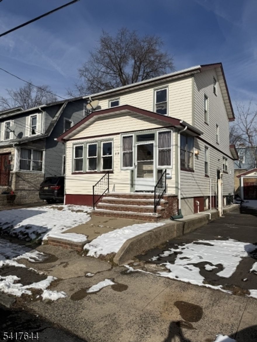 Beautiful wood floors, granite tile kitchen floor with sleek white kitchen cabinets, spacious unfinished basement, and large backyard.