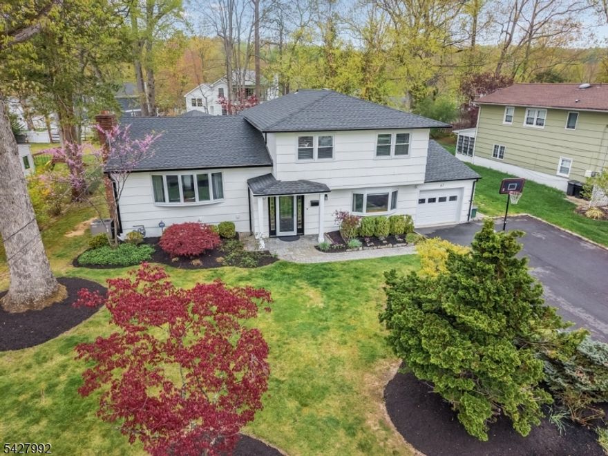 4-BED/2.1 BATH MODERNIZED SPLIT-LEVEL HOME IN FABULOUS OAKWOOD PARK NEIGHBORHOOD! Move right into 67 Woodbine Circle, a tastefully updated home on a quiet street just blocks from Oakwood Park, Passaic River Park, elementary school & thriving downtown New Providence. Three levels accessed by minimal steps provide plenty of space for modern living & entertaining. Entry Level features large Bedroom, Laundry Room, Powder Room & spacious Rec Room with access to the wide, level backyard with paver stone patio, manicured beds, shade trees & storage shed. A few steps from the entry foyer lies the bright Living Room with sunny bay window, cozy wood-burning fireplace & hardwood floors stretching through an amazing open layout encompassing the Dining Room, Eat-in Kitchen & Family Room. High-end touches adorn the open Eat-in Kitchen like crisp white cabinetry to the ceiling, quartz countertops, expansive island with prep sink & stainless steel appliances including Viking 6-burner gas range. Meal prep will be a delight surrounded by the formal Dining Room, casual Breakfast Nook & inviting Family Room with vaulted ceiling & walls of windows on three sides. Primary Ensuite & two more Bedrooms are on the 3rd Level along with two beautifully updated, trendsetting Full Bathrooms. Lowest Level offers incredible storage space. Updated Kitchen & Baths, New Roof & Water Heater, Freshly Painted throughout! Summit, Short Hills Mall & Routes 78 & 24 just minutes away. Don't let this one pass you by!