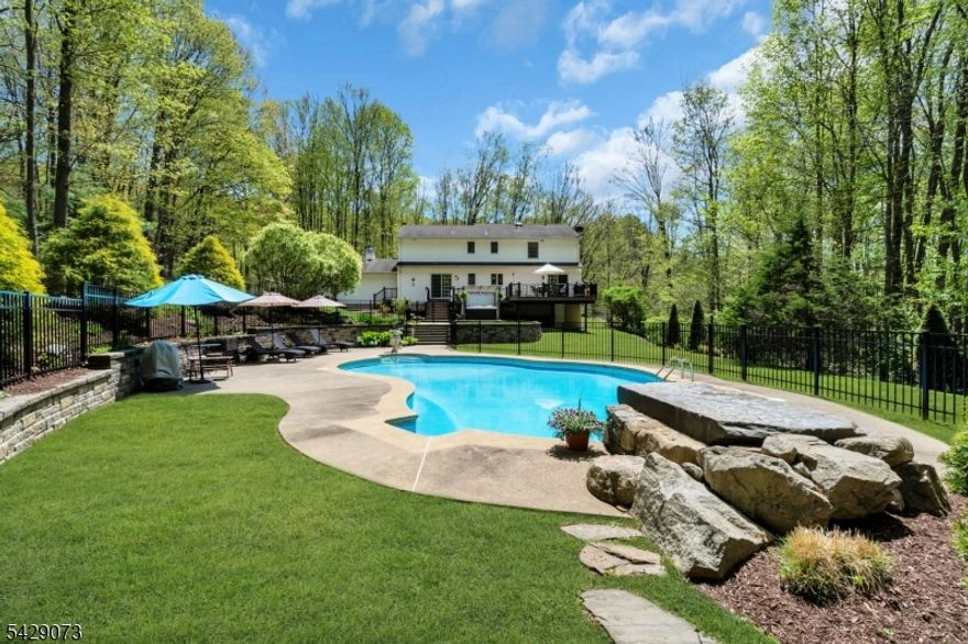 Your own private resort, just minutes from everything.Set on nearly 1.5 acres of fully fenced, lush property, this beautifully updated 4-bedroom, 3-bath colonial offers rare privacy and flexibility. A first-floor den easily functions as a 5th bedroom, office, or guest space.The grounds are magazine-worthy, with landscaping front to back and walking trails along the perimeter. The backyard is the true showstopper, featuring a 20x40 saltwater pool with jump rock, waterfall, automatic vacuum, and programmable color lighting. A brand-new hot tub and expansive Trex like deck create the perfect setting for unforgettable nights, while the charming lemonade porch adds a peaceful place to unwind.Inside, enjoy a warm, functional layout with a fireplace, family room, formal dining room, and second living area. Hardwood floors run throughout, and second-floor laundry adds everyday convenience. The primary suite elevates daily living with heated mirrors, two walk-in closets, including a custom closet with a built-in laundry basket.A full basement with high ceilings offers excellent storage or future potential. Complete with a mudroom, 2-car garage, and a portable generator, this home is truly move-in ready.Located minutes from I-80 and downtown Hackettstown, you get convenience without sacrificing that tucked-away, vacation-every-day feel.Homes like this don't come around often. Don't miss it.