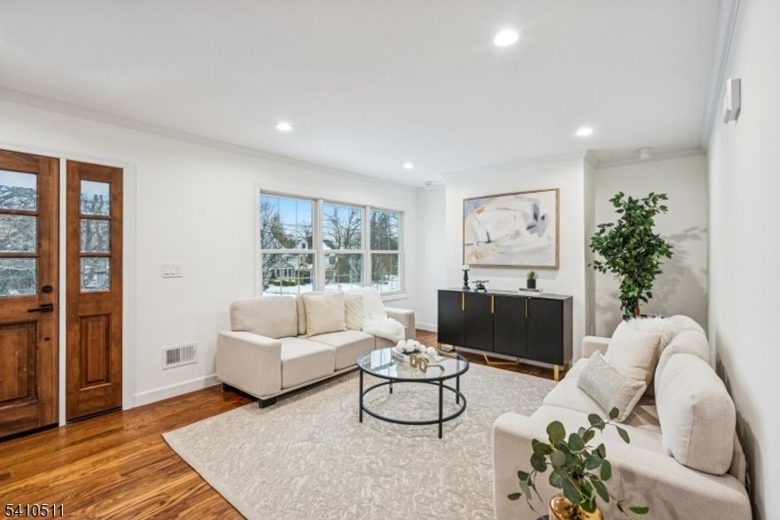 Don't miss the opportunity to own a stunning home that offers unmatched convenience, space, and style in an unbeatable Millburn location. Experience the perfect blend of luxury and function in this 2025 gut remodel 5/6 bedroom 4.1 bath in the highly desirable South Mountain section of Millburn. This home was taken down to the studs and finished across four levels with all new insulation, plumbing, electrical, sheetrock, window, floor, roof etc, and exceptional curb appeal. The open-concept main level features hardwood floors, decorative moldings, and a designer palette. Gourmet Kitchen: Features high-end appliances, custom cabinetry, Quartz topped island opening seamlessly to a sun-drenched den with gas insert Fireplace as well as a formal living room. First floor also boasts an in-law suite.  Primary Suite: A true retreat with a custom large closet and a spa-like bath featuring a double vanity, frameless glass shower. Three additional large bedrooms are available on the second floor. Third Floor: Large office/bedroom with a powder room. Finished Lower Level: Recreation room,  full bath, second laundry /clothing closet and storage  with garage access. A short walk to all Millburn schools, day cares, NJ Transit, Taylor Park, Stores and everything Millburn has to offer. Truly move-in ready!